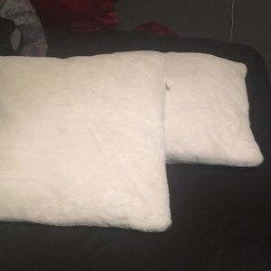 2 medium sized white fluffy pillows